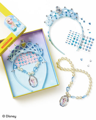 Super Smalls Disney Frozen Headband & Jewelry Kit
Disney Frozen princess costume accessory set including a light blue tiara, matching necklace with pearl beads and Elsa pendant, rhinestone headband, rhinestone sticker sheet, and pearl necklace with blue bead accents, shown with its packaging on a white background.
