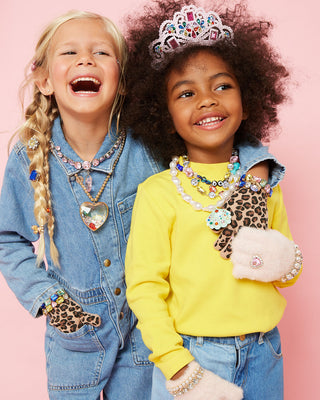 Super Smalls Jungle Jeweled Gloves
Two children wearing colorful jewelry against a pink background