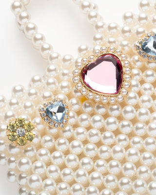 Super Smalls Pearl of the Party Handbag
Pearl necklace with heart-shaped gemstones on a white background