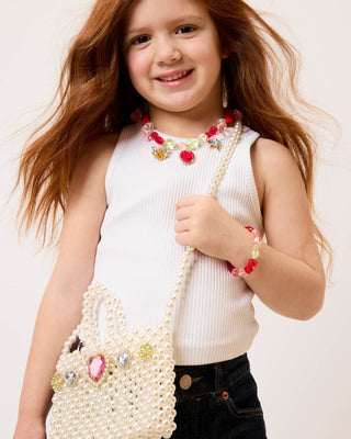 Super Smalls Pearl of the Party Handbag
Young girl holding a pearl-handled bag with decorative elements on a plain background