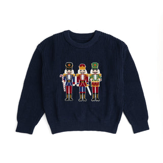 Sweet Wink Christmas sweater featuring a Nutcracker patch, festive holiday knitwear with colorful holiday-themed design.