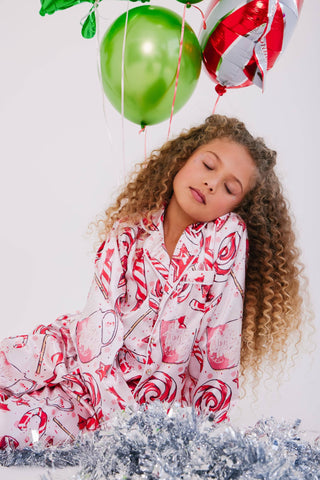 Lola and The Boys Sweet Winter Silky Set
Young girl in a candy-themed outfit with balloons against a white background