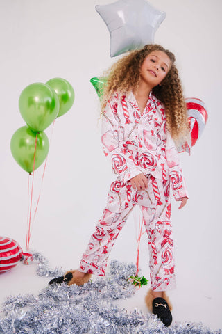 Lola and The Boys Sweet Winter Silky Set
Child wearing a candy-themed pajama set with balloons and decorations on a white background