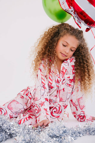 Lola and The Boys Sweet Winter Silky Set
Young girl in a candy-themed outfit with balloons and tinsel on a white background