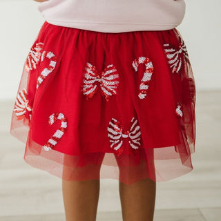 Sweet Wink Candy Cane Coquette Sequin Christmas Tutu Red skirt with candy cane and bow designs on a plain background