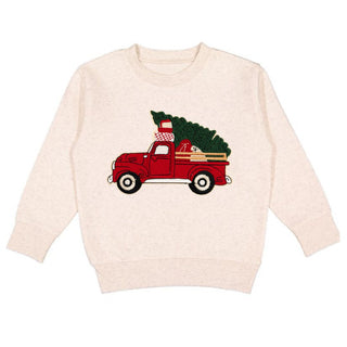 Sweet Wink Christmas Truck Patch Sweatshirt - Natural
Beige sweatshirt with a red truck and Christmas tree design on a white background