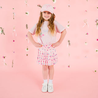 Sweet Wink Cherry Good Day short sleeve T-shirt featuring a cherry graphic, paired with a ballet-themed baseball hat.
