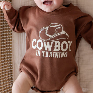Sweet Wink Cowboy In Training Western Long Sleeve Romper
Baby wearing a brown 'Cowboy in Training' onesie against a neutral background