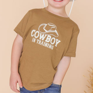 Sweet Wink Cowboy In Training Western Short Sleeve T-Shirt
Child wearing a brown t-shirt with 'Cowboy in Training' text and graphic on a beige background