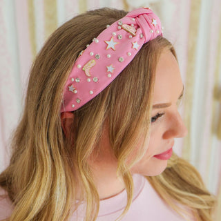 Sweet Wink Cowgirl Cutie Western Gemstone Headband
Woman wearing a pink headband with star and moon designs against a light background