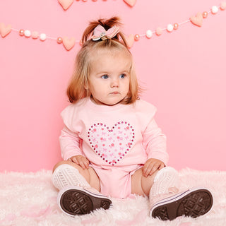 Sweet Wink Dainty Rose Pearl Heart Patch Long Sleeve Romper - Ballet
Child wearing a pink outfit with a heart design on a pink background