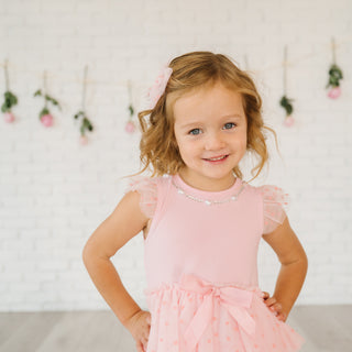 Sweet Wink Flocked Heart Valentine's Day Tiered Short Sleeve Tutu Dress
Young girl in a pink dress with a decorative headband against a light background