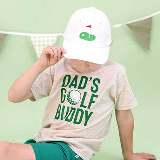 White baseball hat by Sweet Wink with front golf tee flag patch, casual design, adjustable brim, perfect for golf or everyday wear.