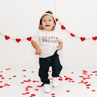 Sweet Wink Heartbreaker Valentine's Day Short Sleeve T-Shirt - Natural Heather
Child wearing a 'Heart Breaker' shirt with red heart decorations on a white background