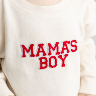 Sweet Wink Mama's Boy Varsity Patch Valentine's Day Long Sleeve Romper - Natural
White sweatshirt with red text 'MAMA'S BOY' on a white background