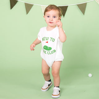 White Sweet Wink New To The Club patch short sleeve romper on a model, showcasing its casual onesie style and trendy design.