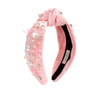 Sweet Wink Pearl Heart Gemstone Headband - Small
Pink decorative headband with pearls and bows on a white background
