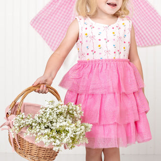 Sweet Wink Peony Floral Tank Tutu Dress
Child wearing a pink dress with floral embroidery, holding a basket of flowers against a white background.