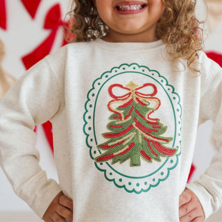 Sweet Wink sequin Christmas tree patch sweatshirt featuring festive embroidery and a cheerful holiday design.