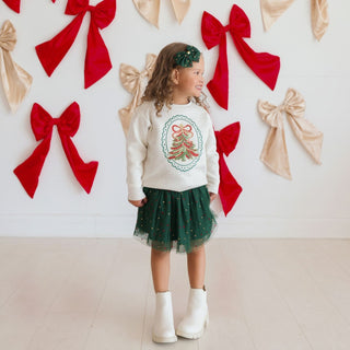 Sweet Wink sequin Christmas tree patch sweatshirt featuring festive embroidery, rhinestones, and a cozy sweater design.