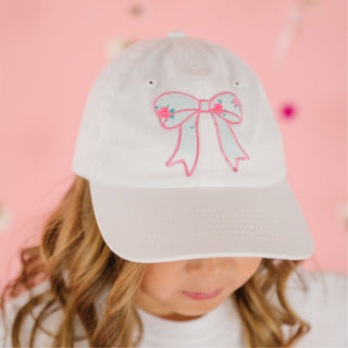 Sweet Wink Sky Blue Floral Bow Patch Baseball Hat - White
White cap with pink bow design on a pink background