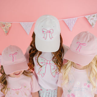 Sweet Wink sky blue floral bow patch baseball hat in white with a decorative bow and floral details.
