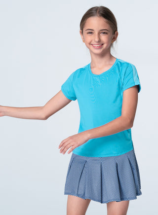 Lucky In Love Boxy Short Sleeve Tee - Ocean
Young girl wearing a blue top and polka dot skirt on a white background