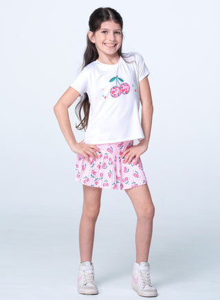Lucky In Love Short Sleeve Tee - Disco Cherry
 Young girl wearing a white t-shirt with floral design and pink shorts on a white background