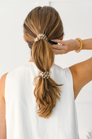 Teleties Luxury Living Hair Ties - Large
Person styling a ponytail with decorative hair ties against a white background