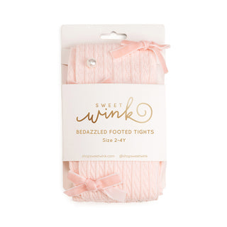 Sweet Wink Bedazzled Coquette Tights - Pink
Packaged pink bedazzled footed tights with 'Sweet Wink' branding on a white background