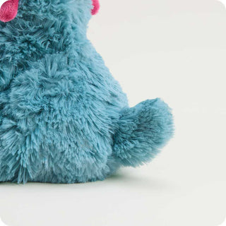 Triceratops Warmies Junior
Close-up of a blue plush toy with pink accents on a white background