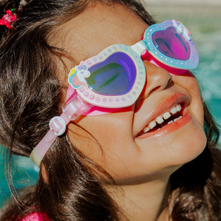 Bling2o  Uniglow Unicorn Heart Swim Goggles
Child wearing colorful goggles with a blurred pool background