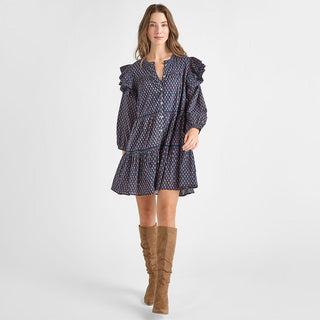 Pink Chicken Womens Kalani Dress - Navy Carnation Woman wearing a patterned dress with long brown boots on a white background