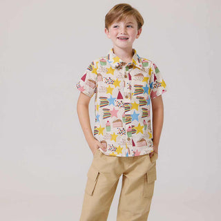 Pink Chicken Girls Jennifer Dress - Birthday Star Child wearing a colorful patterned shirt and beige pants on a plain background