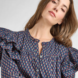 Pink Chicken Womens Kalani Dress - Navy Carnation Woman wearing a navy blue floral blouse against a white background