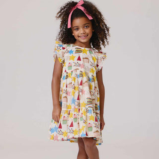 Pink Chicken Girls Jennifer Dress - Birthday Star Young girl wearing a colorful dress with star, moon, and cloud patterns on a plain background