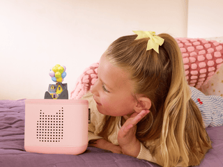 Tonies Character - Disney & Pixar: Up
Child listening to a pink speaker on a bed