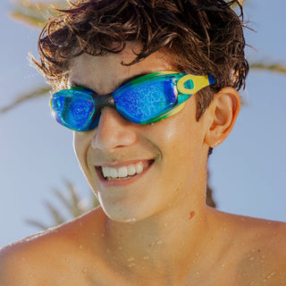 Bling2o Voyage Swim Goggles
Person wearing colorful swim goggles with a clear blue sky background