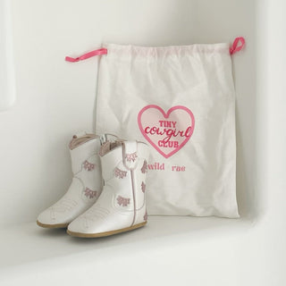 Wild & Rae cowgirl baby booties in white with pink bows, soft leather boots for infants with cute bow accents.
