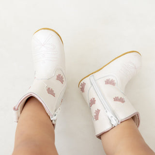 White cowgirl baby booties by Wild & Rae with pink bows, soft leather boots for infants with adorable bow details.
