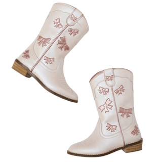 Wild & Rae cowgirl boots in white with pink bow accents, featuring a stylish Western-inspired design and pointed toe.