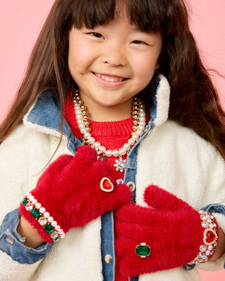 Super Smalls Ruby Red Jeweled Gloves
Child wearing red mittens with decorative elements on a pink background