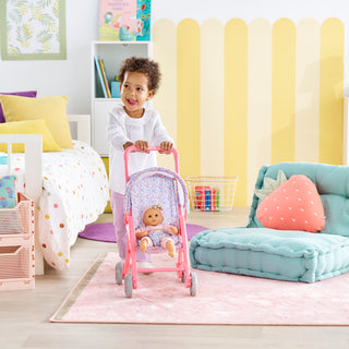 Corolle Floral Baby Doll Stroller with Folding Canopy for 12" Doll
Child playing with a doll in a colorful bedroom
