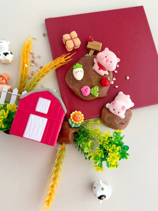 Earth Grown KidDoughs EGKD Farm KidDough Play Kit
Playful arrangement of animal-themed cookies on a red book with decorative elements.