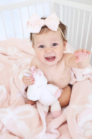 Light pink Caden Lane Cuddlelane Luxe Blanket with bow details, soft and cozy for baby or toddler comfort.