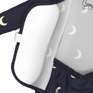 Bonsie Footie - G'night Moon
Close-up of a baby sleep sack or wearable blanket by Bonea, featuring a navy blue outer layer with a cream crescent moon pattern, a white fleece inner lining, and a light gray printed panel with moon motifs.