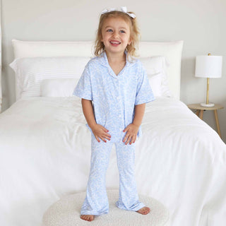 Caden Lane girl's two-piece flare lounge pajama set in blue with bow details, soft fabric, perfect for comfortable bedtime wear.