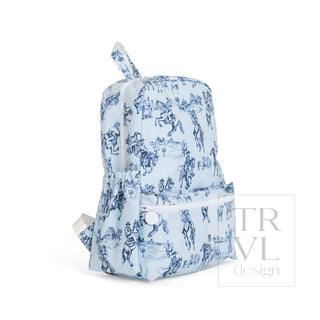 TRVL Designs Backpacker - Cowboy Toile
A light blue backpack with a dark blue toile de Jouy print, featuring a front zippered pocket and a top carry handle, shown against a plain white background.