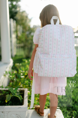 TRVL Designs Backpacker - Ribbon Floral Pink
Person wearing a white backpack with pink patterns in an outdoor setting
