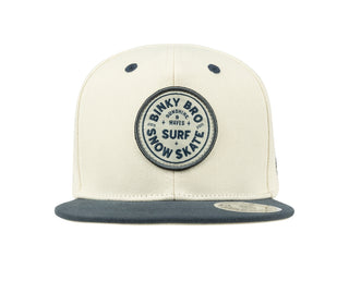 BinkyBro Kids Belhaven Hat Beige and gray cap with a circular logo on a white background
